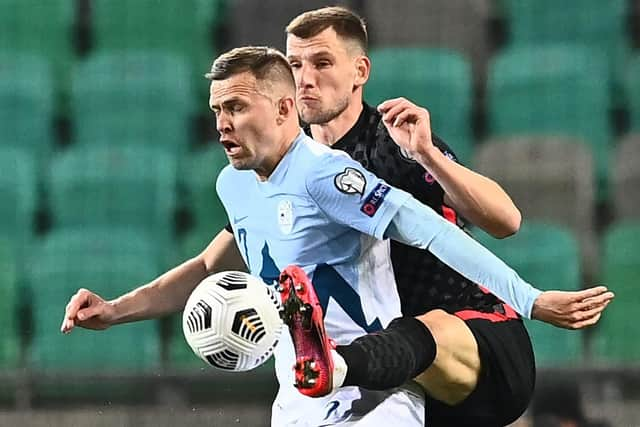 Slovenia's midfielder Josip Ilicic (L) fights for the ball with and Croatia's defender Borna Barisic during the FIFA World Cup Qatar 2022 Group H qualification football match between Slovenia and Croatia at The Stozice Stadium in Ljubljana, Slovenia. (Photo by JOE KLAMAR/AFP via Getty Images)