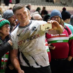 Saracens' Owen Farrell takes a selfie with fans after the match against Leicester.