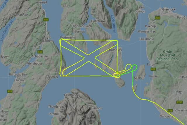 Mystery pilot traces St Andrew's Cross over Scottish islands.