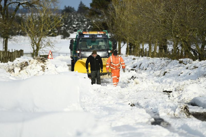 A snow plough can be seen stuck in a snow drift after attempting to clear the snow in Lamancha, Scotland.