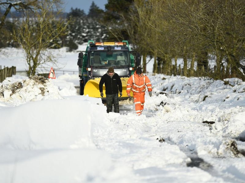 A snow plough can be seen stuck in a snow drift after attempting to clear the snow in Lamancha, Scotland.