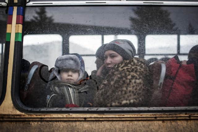 A woman and a young boy sit in a bus before fleeing the Ukrainian city of Debaltseve. Picture: Manu Brabo/AFP/Getty