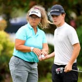 Frank Kennedy with caddie Fanny Sunesson on the putting green at The Belfry, where the young Englishman is making his prodessional debut in the Betfred British Masters hosted by Sir Nick Faldo. Picture: Andrew Redington/Getty Images.