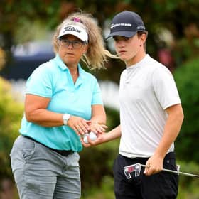 Frank Kennedy with caddie Fanny Sunesson on the putting green at The Belfry, where the young Englishman is making his prodessional debut in the Betfred British Masters hosted by Sir Nick Faldo. Picture: Andrew Redington/Getty Images.