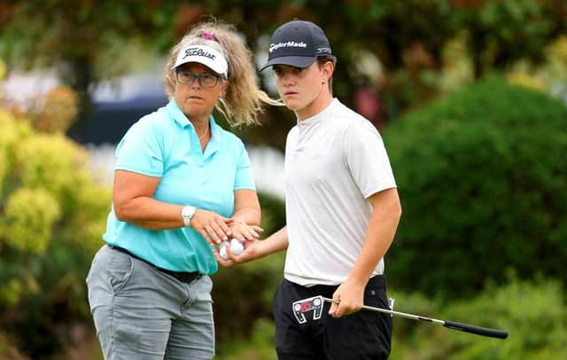 Frank Kennedy with caddie Fanny Sunesson on the putting green at The Belfry, where the young Englishman is making his prodessional debut in the Betfred British Masters hosted by Sir Nick Faldo. Picture: Andrew Redington/Getty Images.