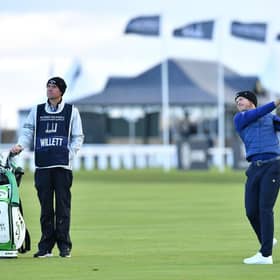 Watched by caddie Jonathan Smart, Danny Willett plays his second shot to the first hole during the third round of the Alfred Dunhill Links Championship. Picture: Mark Runnacles/Getty Images.