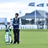 Watched by caddie Jonathan Smart, Danny Willett plays his second shot to the first hole during the third round of the Alfred Dunhill Links Championship. Picture: Mark Runnacles/Getty Images.