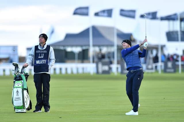 Watched by caddie Jonathan Smart, Danny Willett plays his second shot to the first hole during the third round of the Alfred Dunhill Links Championship. Picture: Mark Runnacles/Getty Images.