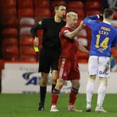 Kevin Clancy shows Johnny Hayes and Ryan Kent a yellow card during Aberdeen's 1-1 draw with Rangers. (Photo by Craig Williamson / SNS Group)