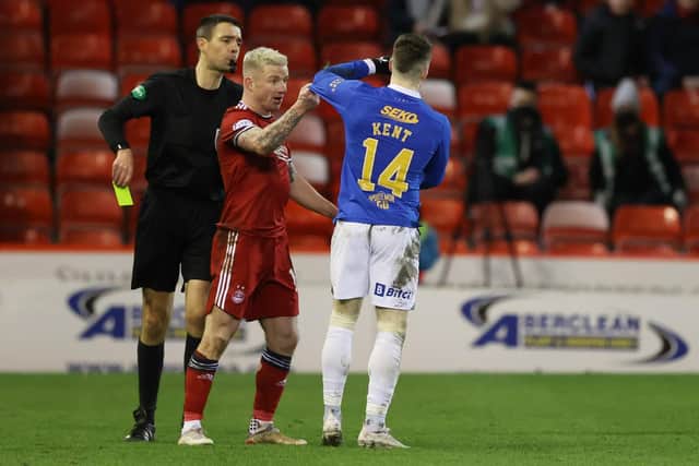 Kevin Clancy shows Johnny Hayes and Ryan Kent a yellow card during Aberdeen's 1-1 draw with Rangers. (Photo by Craig Williamson / SNS Group)