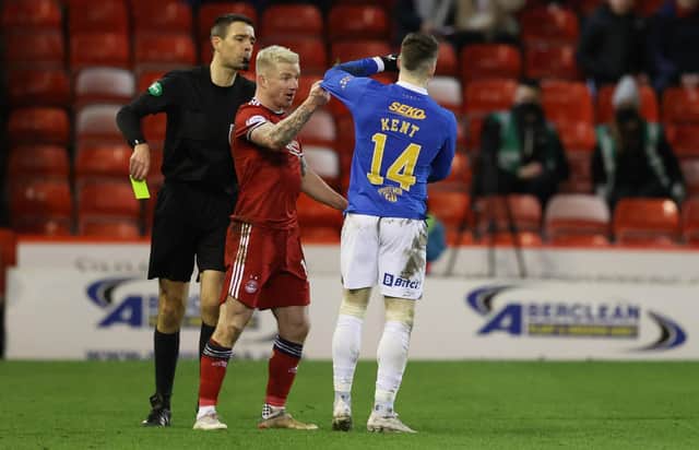 Kevin Clancy shows Johnny Hayes and Ryan Kent a yellow card during Aberdeen's 1-1 draw with Rangers. (Photo by Craig Williamson / SNS Group)