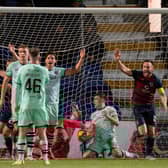 Ross County levelled through Yan Dhanda's corner, despite Hibs' best protestations.