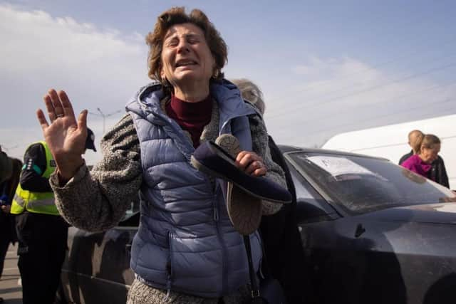 Natalia, 50 of Mariupol, reacts after arriving at an evacuation point for people fleeing Mariupol, Melitopol and the surrounding towns under Russian control. Dozens of refugees were expected to arrive here from Mariupol, including the Azovstal steel facility, following extensive negotiations between representatives of Ukraine, Russia, the United Nations and the International Committee of the Red Cross. (Photo by Chris McGrath/Getty Images)