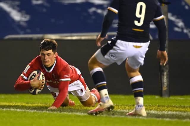 Wales wing Louis Rees-Zammit crosses for his first try during the Guinness Six Nations match between Scotland and Wales at Murrayfield on February 13, 2021, which saw Wales triumph 24-25.