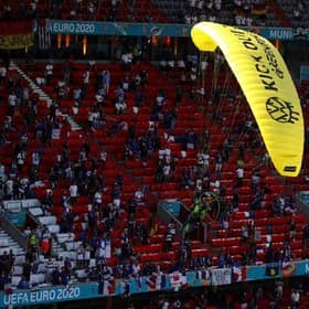 A Greenpeace protester flew into the stadium ahead of France vs Germany at Euro 2020. Photo: Getty Images