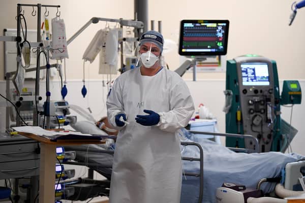 A member of staff at University Hospital Monklands attends to a Covid-positive patient on the ICU ward in 2021 in Airdrie. Picture: Jeff J Mitchell/Getty Images