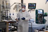A member of staff at University Hospital Monklands attends to a Covid-positive patient on the ICU ward in 2021 in Airdrie. Picture: Jeff J Mitchell/Getty Images