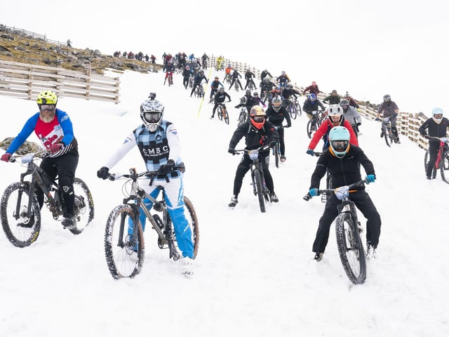 Cyclists take part in MacAvalanche, a mass start mountain bike race through the snow, descending over 900m from the summit of Aonach Mor in the Nevis Range near Fort William. Jane Barlow/PA Wire