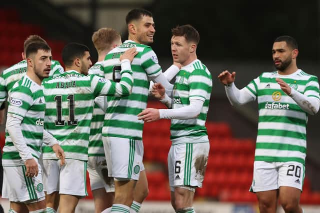 Celtic's Nir Bitton celebrates with team-mates after making it 3-1.