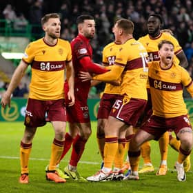 Motherwell players surround Liam Kelly after his penalty save from Celtic's Luis Palma. (Photo by Craig Williamson / SNS Group)