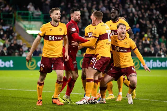 Motherwell players surround Liam Kelly after his penalty save from Celtic's Luis Palma. (Photo by Craig Williamson / SNS Group)