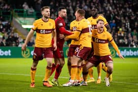 Motherwell players surround Liam Kelly after his penalty save from Celtic's Luis Palma. (Photo by Craig Williamson / SNS Group)
