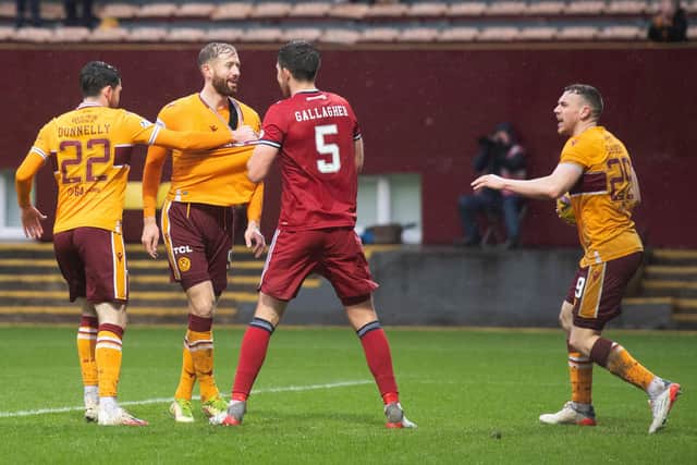 Kevin van Veen and Aberdeen defender Declan Gallagher exchange words after the Motherwell striker's equaliser  (Photo by Mark Scates / SNS Group)