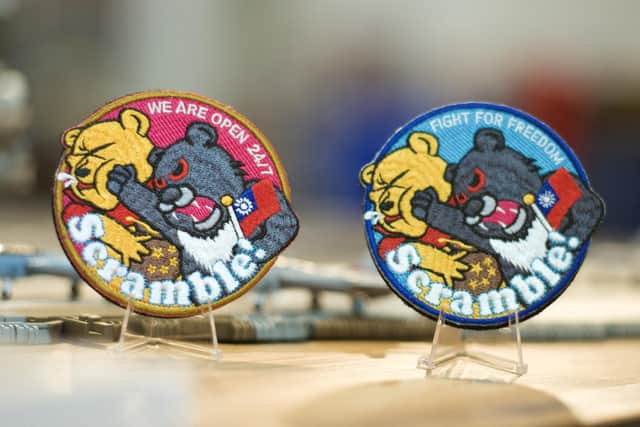 Badges depicting a Formosan black bear holding a Taiwanese flag punching Winnie-the-Pooh are being worn by some of Taiwan's air force pilots as a defiant message to Chinese leader Xi Jinping (Picture: Sam Yeh/AFP via Getty Images)