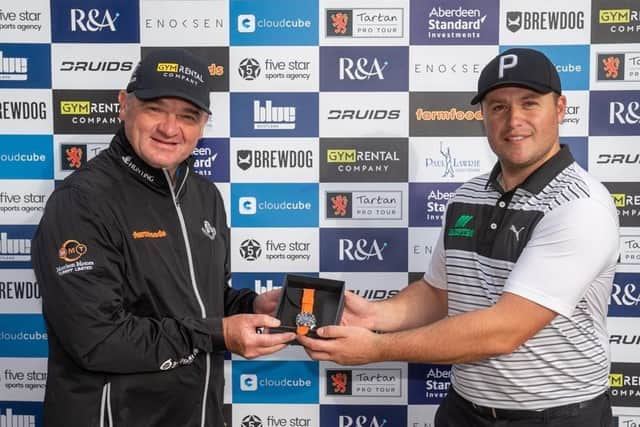 Paul Lawrie, who set up the Tartan Pro Tour, presents Neil Fenwick with a watch after one of his victories on the circuit last season. Picture: Kenny Smith