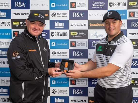 Paul Lawrie, who set up the Tartan Pro Tour, presents Neil Fenwick with a watch after one of his victories on the circuit last season. Picture: Kenny Smith