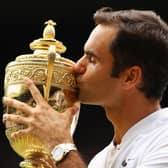 Roger Federer kisses the trophy as he celebrates victory after the men's singles final at Wimbledon in 2017 (Picture: Clive Brunskill/Getty Images)