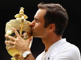 Roger Federer kisses the trophy as he celebrates victory after the men's singles final at Wimbledon in 2017 (Picture: Clive Brunskill/Getty Images)