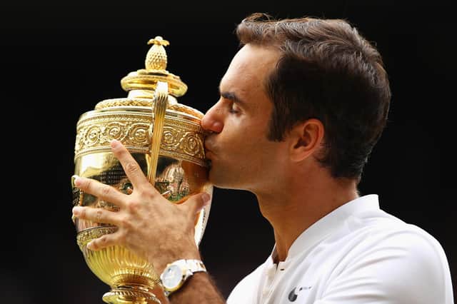 Roger Federer kisses the trophy as he celebrates victory after the men's singles final at Wimbledon in 2017 (Picture: Clive Brunskill/Getty Images)