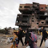Palestinians fleeing the fighting in war-torn Gaza walk on Salaheddine road in the Zeitoun district of the southern part of the Gaza Strip. Picture: Mahmud Hams/AFP via Getty Images