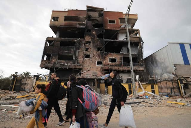 Palestinians fleeing the fighting in war-torn Gaza walk on Salaheddine road in the Zeitoun district of the southern part of the Gaza Strip. Picture: Mahmud Hams/AFP via Getty Images