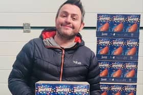 Dan Dafydd with just some of the hundreds of Easter eggs he mistakenly ordered for Sinclair General Stores on Sanday (Picture: SWNS)