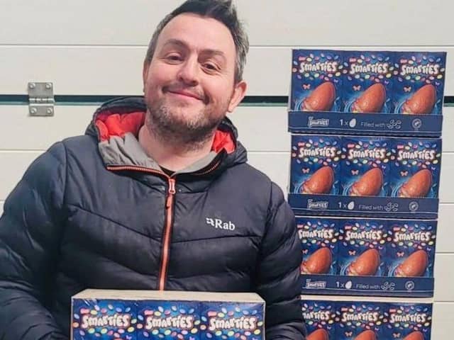 Dan Dafydd with just some of the hundreds of Easter eggs he mistakenly ordered for Sinclair General Stores on Sanday (Picture: SWNS)