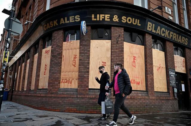 Members of the public walk through the Merchant City prior to level four restrictions coming into place in Glasgow. Picture: Jeff J Mitchell/Getty Images