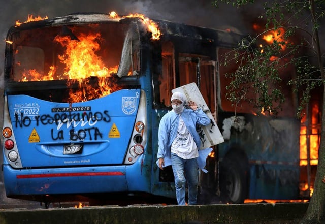 A public transportation bus in flames during a protest against the tax reform bill launched by Colombian President Ivan Duque (Photo: PAOLA MAFLA/AFP via Getty Images)