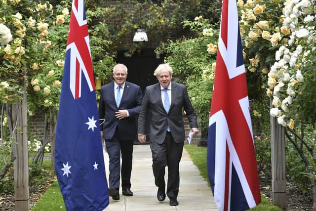 Prime Minister Boris Johnson, right, walks with Australian Prime Minister Scott Morrison after their meeting, in the garden of 10 Downing Street in London in June. Picture: Dominic Lipinski/Pool Photo via AP