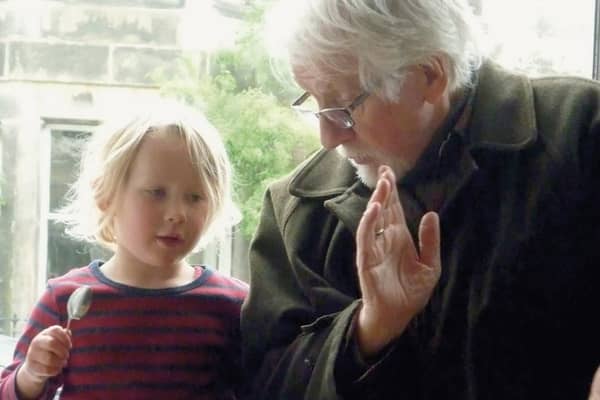 The late Robin Morton, teaching his granddaughter to play the spoons. A re-edited version of his 1970 book Folksongs Sung in Ulster has been published by Kinmor Music.