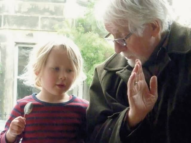 The late Robin Morton, teaching his granddaughter to play the spoons. A re-edited version of his 1970 book Folksongs Sung in Ulster has been published by Kinmor Music.