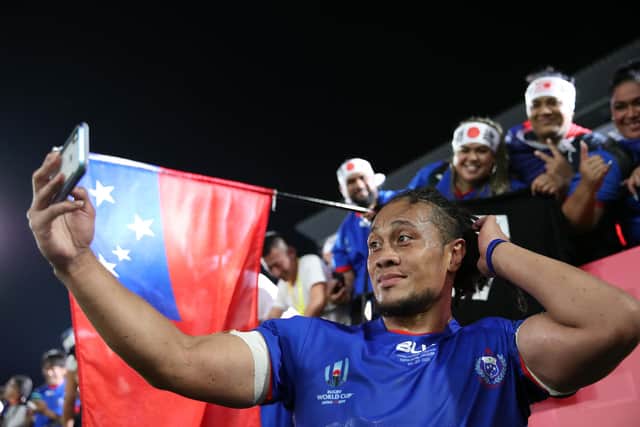 Samoa's TJ Ioane takes selfies with fans at the 2019 Rugby World Cup in Japan.