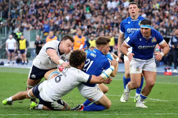 Stephen Varney scores Italy's third try in the 31-29 win over Scotland despite the efforts of Jack Dempsey and Andy Christie. (Photo by Giampiero Sposito/Getty Images)