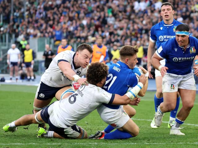 Stephen Varney scores Italy's third try in the 31-29 win over Scotland despite the efforts of Jack Dempsey and Andy Christie. (Photo by Giampiero Sposito/Getty Images)