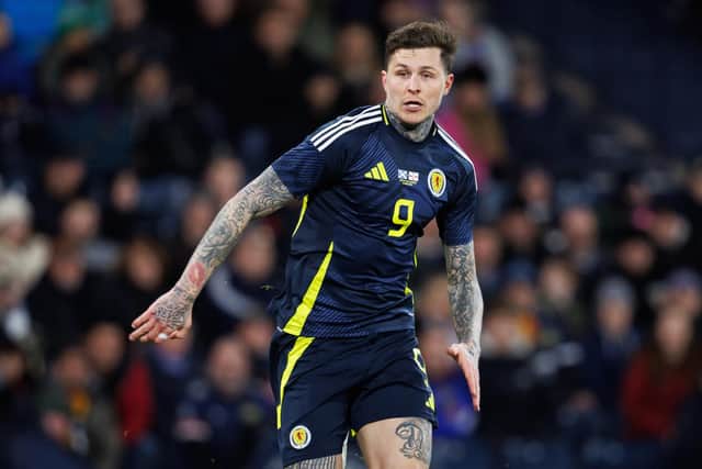 Lyndon Dykes' Scotland participation is in doubt after a knee injury.