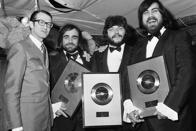 Aphrodite's Child - from left, Demis Roussos, Loukas Sideras and Vangelis - receiving a gold disc from Phonogram CEO Louis Hazan in 1969  (Picture: AFP via Getty Images)
