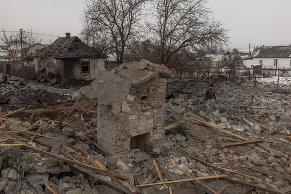 A man stands next to destroyed houses following a Russian shelling in Kyiv on Monday (Picture: Roman Pilipey/AFP via Getty Images)
