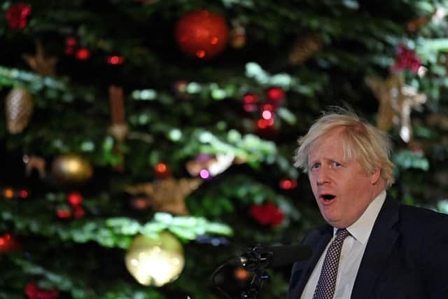Boris Johnson stands in front of the Downing Street Christmas tree. Picture: Justin Tallis/AFP via Getty Images