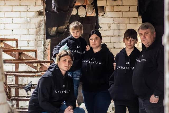 Tatyana Shpygunova and her family in the wreckage of their house, which was shelled in March 2022.